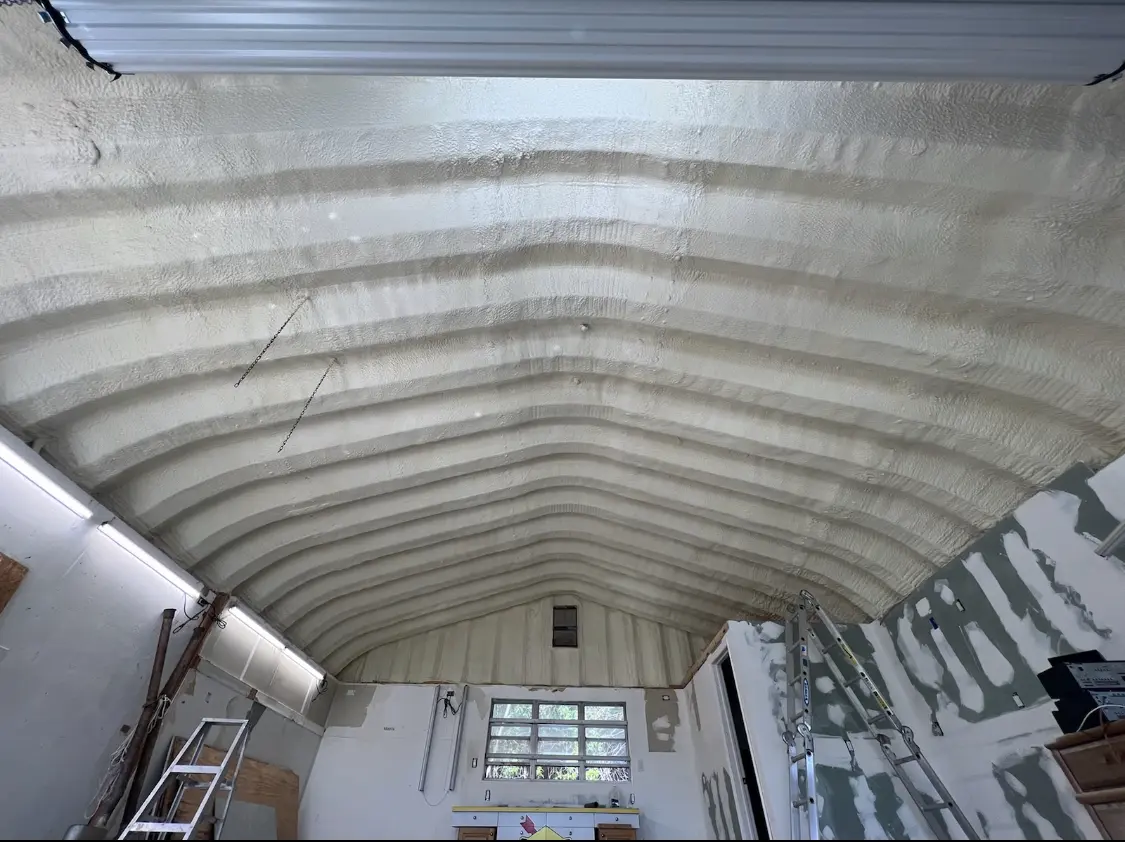 Spray polyurethane foam applied to the underside of a metal roof deck in Speedway